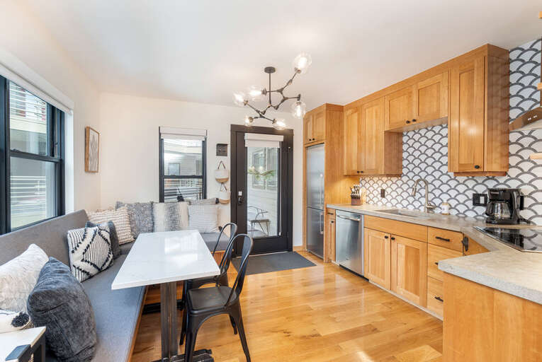 You enter into the kitchen and dining room which is modern and clean. You enter into the kitchen and dining room which is modern and clean.