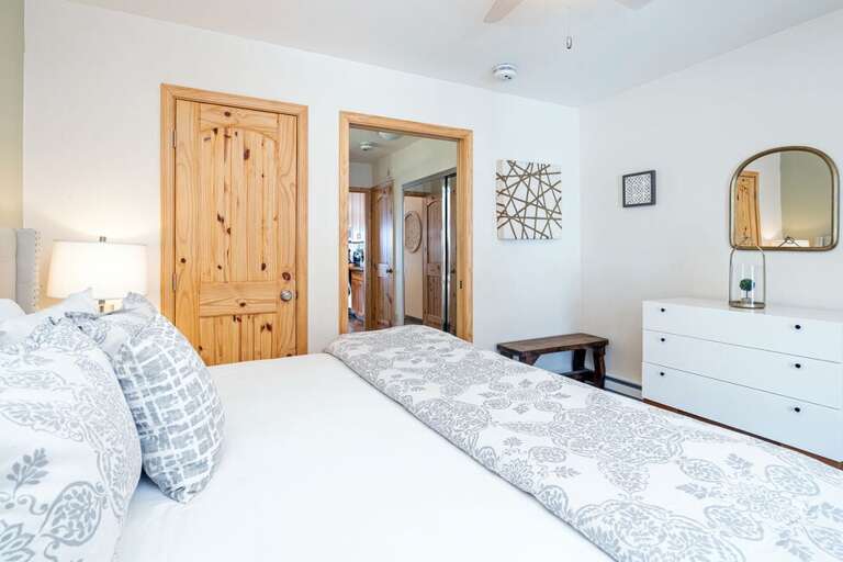 From the bedroom, you'll pass through the hallway with bathroom and closet access to the kitchen and living area.