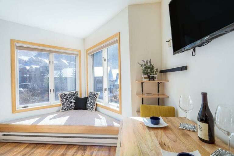 The smart dining area expands to seat 4 when needed and offers views out the bay window toward the mountains.