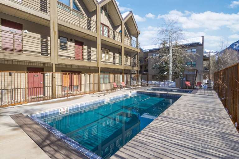 Sunlit Swimming Pool With Surrounding Structures