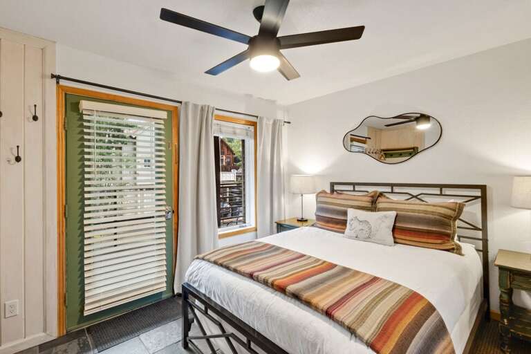 Cozy bedroom featuring a queen bed and a dresser for convenient storage.