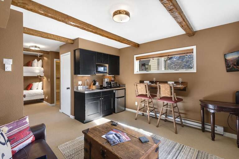 The living area is great for relaxing and offers  a flat screen TV , and bar seating for two.