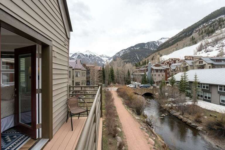 The bedroom opens to a private balcony overlooking the San Miguel River and River Trail.