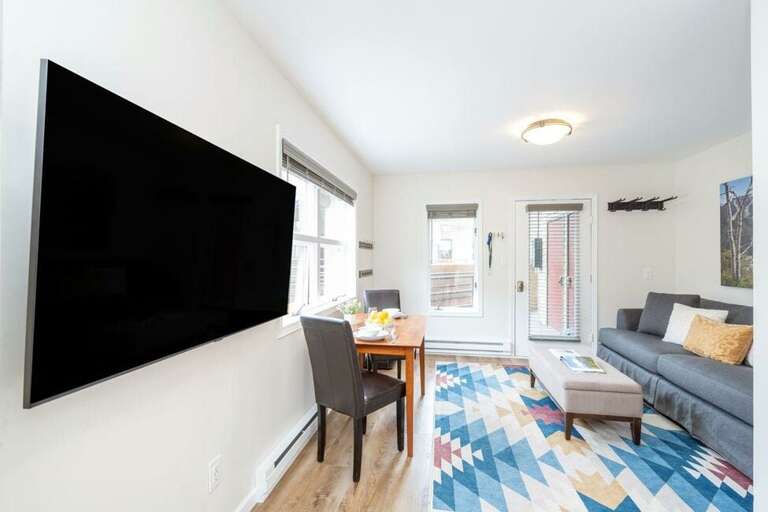 The living area has a flat screen tv for a cozy night in.