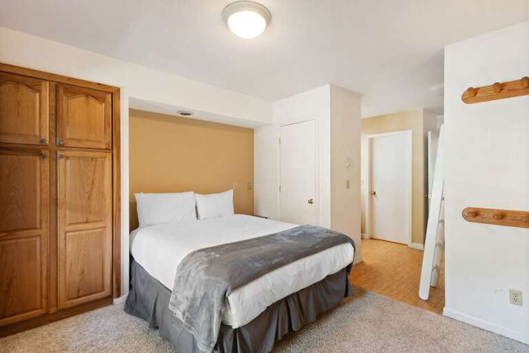 Primary Queen bedroom with dresser, wardrobe and closet