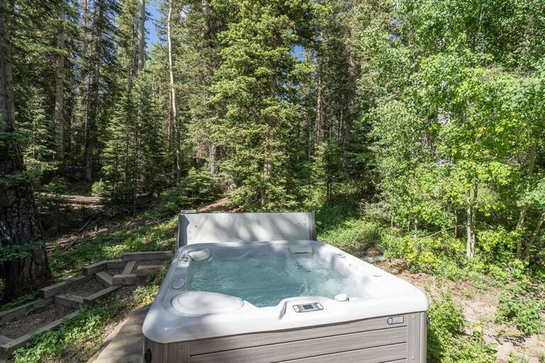 Relax under the summer sky in the private hot tub.
