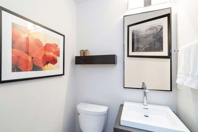 1/2 bathroom with vanity and toilet on the main level.