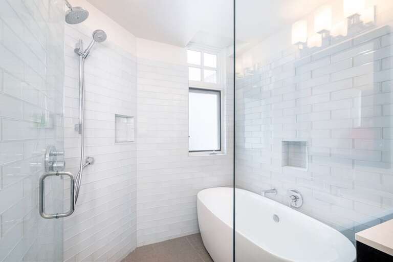 Enjoy a cozy bath in this deluxe bathtub  and beautiful shower room.