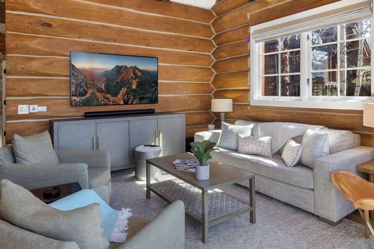 Cozy living area with private deck is the perfect space for game/movie night.