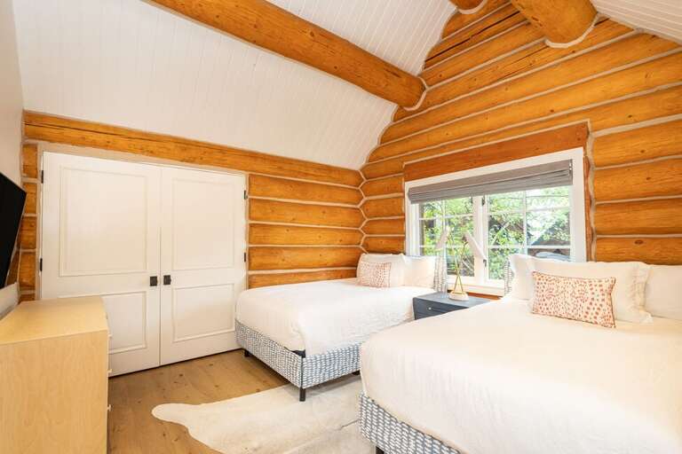 The Second Floor above the main level  hosts Guest Room number 2.  This room features two double beds as well as an ensuite bathroom.