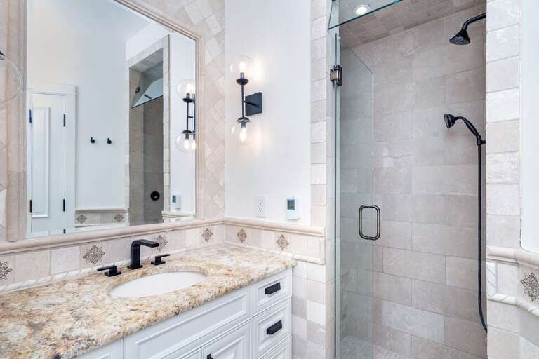 The Primary ensuite features a large tiled walk-in shower and vanity.