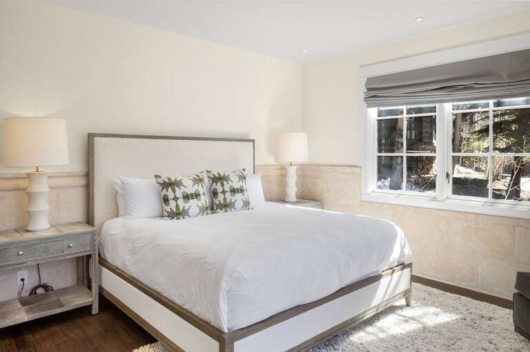 The primary suite, located on the bottom level provides guests with a private deck, ensuite bathroom and spacious area to relax.