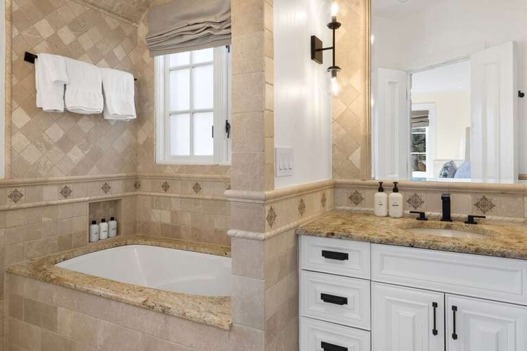 Spa-inspired bathroom featuring a deep soaking tub and a sleek step-in shower for ultimate relaxation.