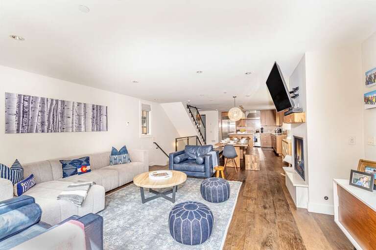 Tri-level plan offers an open living space on the mid-level with fireplace, TV, dining area, kitchen, and balcony. Tri-level plan offers an open living space on the mid-level with fireplace, TV, dining area, kitchen, and balcony.