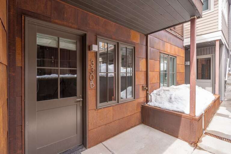 Unit Door and number.  This building is one half of a duplex .  The main Entrance is located on the east side of the building.  Access can also be gained through the garage.