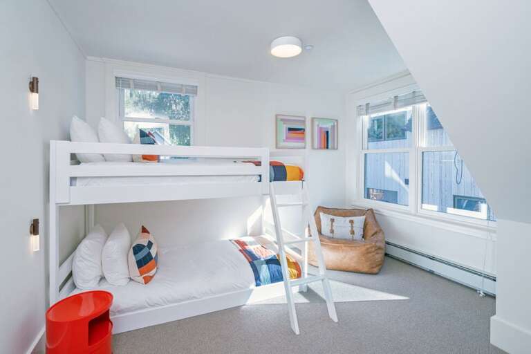 The second bunk room features a set of bunks and a cozy leather bean bag.