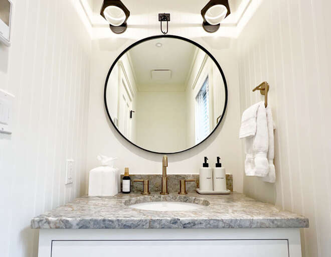 The entryway half bath is the only restroom located on the entry level of this Beautiful Home.