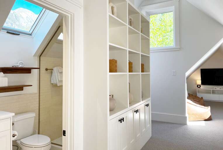 The third floor consists of two bunk rooms, a shared bathroom, small desk area and a media room.