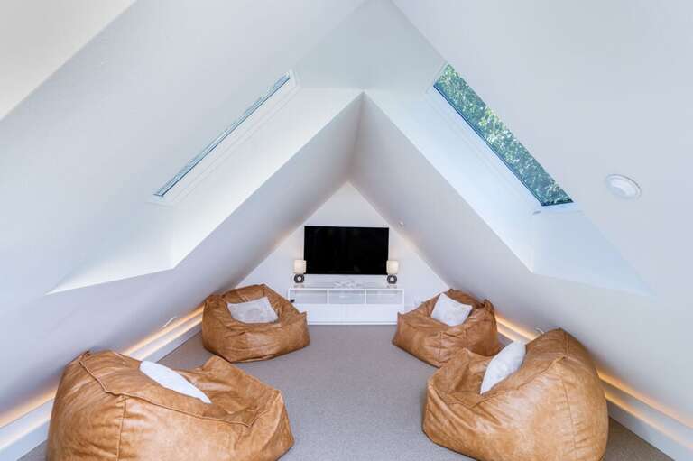 Huge media room with giant leather bean bags.