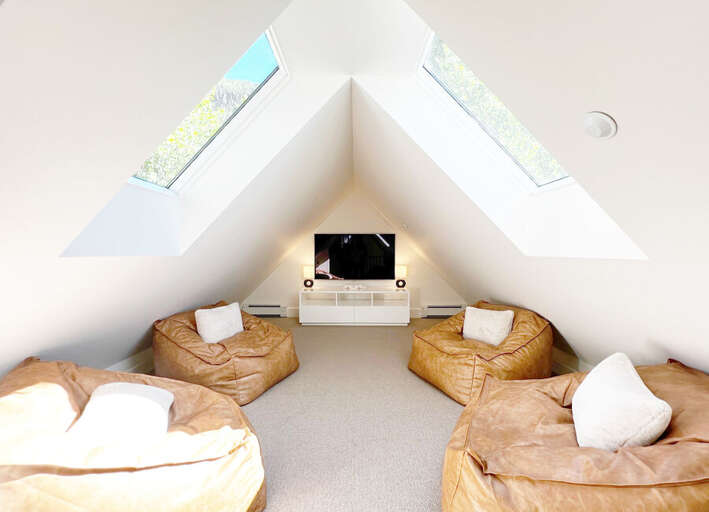 Huge media room with giant leather bean bags. The perfect place for the kids hideout, play and movie room.