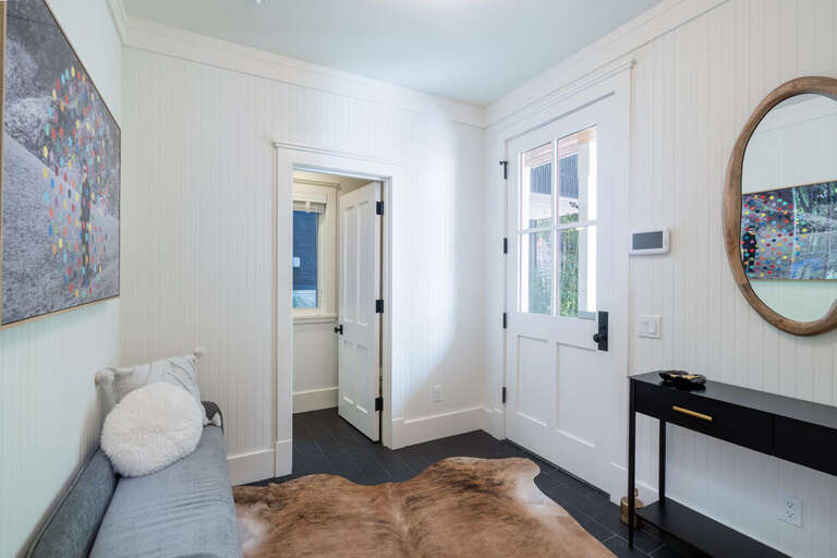 The Main entrance to the house welcomes you into a spacious foyer with half bathroom.