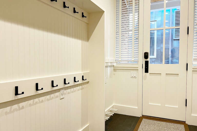 This mud room is a gear heads dream with hooks for jackets, baskets for shoes and gear and space for everyone to come and go.