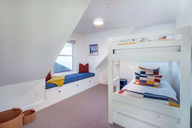 Perfect for kids or extra guests, one of two bunk rooms offers a bunk bed with trundle and a charming bay window.