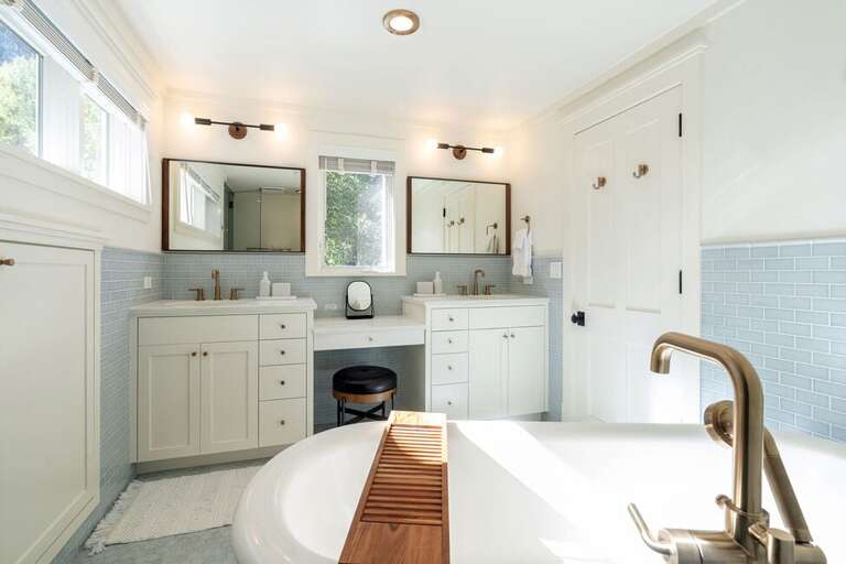 The primary Bedroom has a Beautiful remodeled en suite bathroom with high end fixtures, his and her vanities,  large soaking tub and a spacious walk-in shower.