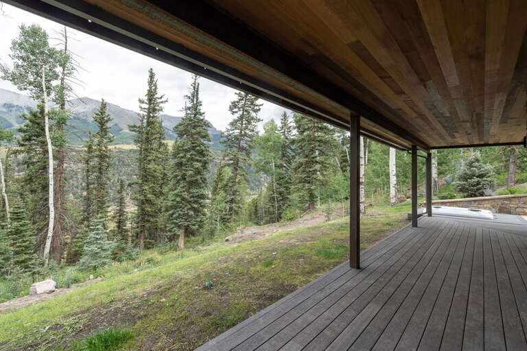 The bottom level of Cloudview features a huge outdoor covered porch and hot tub area. The porch can be accessed via the media room as well as Guest Room Two.