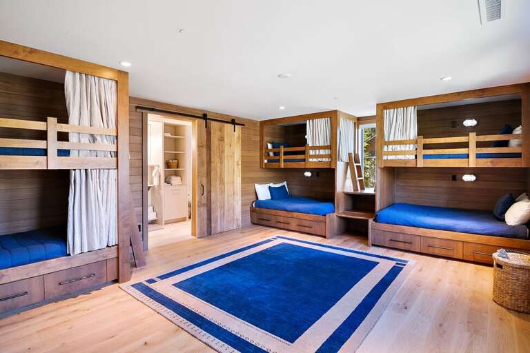 The Bunk room located one flight  below the main level features three sets of twin bunks and ensuite bathroom.