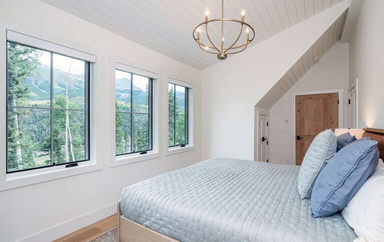 This cozy room has his and her closets, a desk for remote working and incredible views if the mountains.