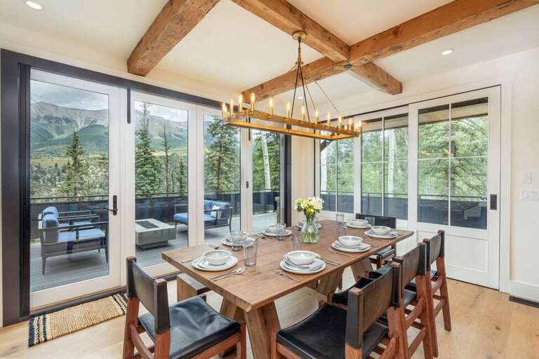 The dining Table easily seats 8-10 people and offers stunning views of the San Sophia Ridge. Open the sliding doors and you have access to a stunning open deck.