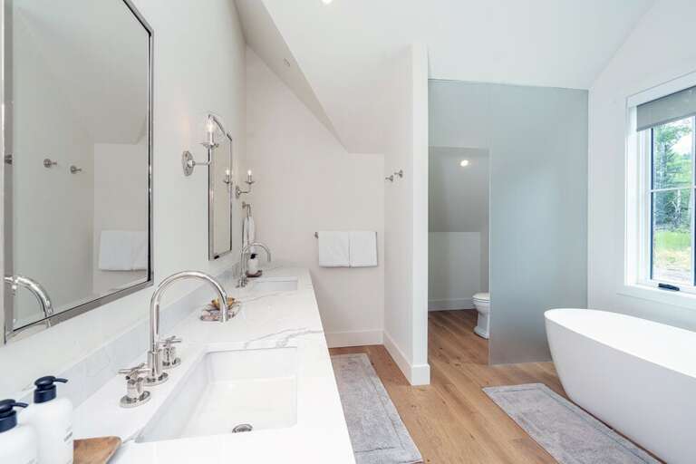 Guest Room Ensuite en suite with a double vanity and private lavatory, large soaking tub and walk-in shower.