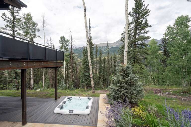 Large bottom level porch features an 8 man hot tub, plenty of lounging and entertaining space and just minutes from the Jurassic Bike/hiking trail.