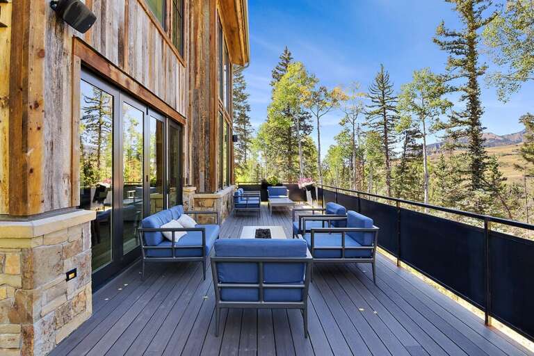 Off the main level and dining area, This stunning home offers easy access to a spacious  L-shaped deck.  Perfect for watching sunsets, entertaining guests and enjoying the mountain vibes.