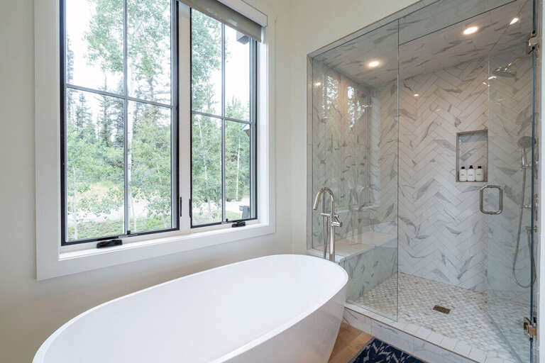The Primary ensuite features a large soaking tub and tiled walk-in shower .
