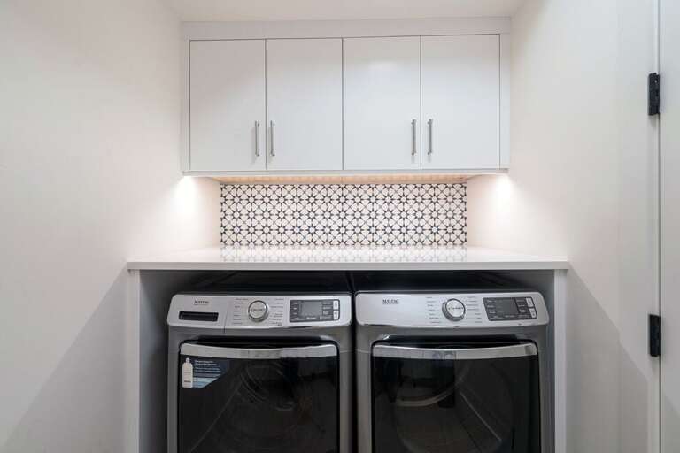 The seperate laundry room, located on the bottom level,  offers top of the line appliances for all your laundry needs with plenty of storage space.