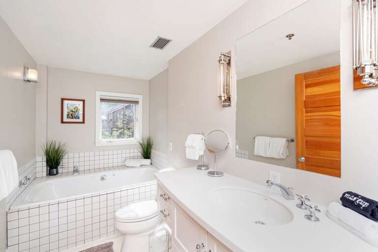 Primary en suite bathroom offers  large soaking tub with separate shower unit.