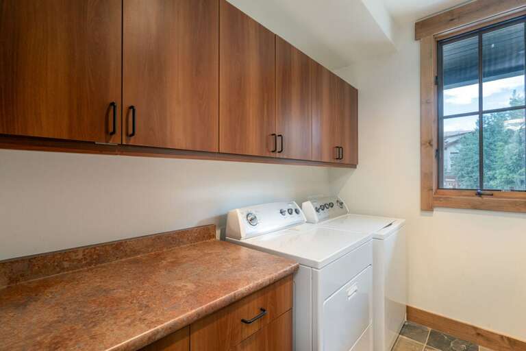 Full laundry room with washer and dryer and folding area.