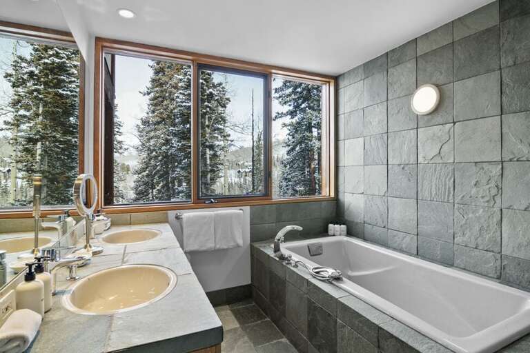Double vanity, large soaking tub and great views.