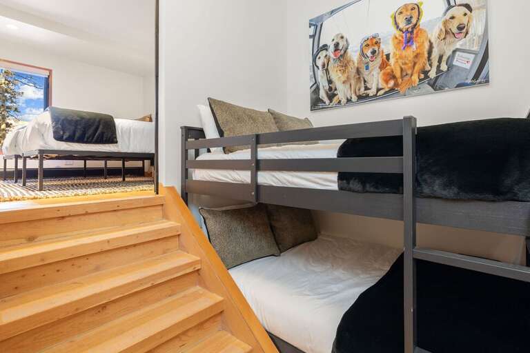 Guest Room Two features twin bunks with stairs leading to Guest Room Three.  These guest rooms share an ensuite bathroom.