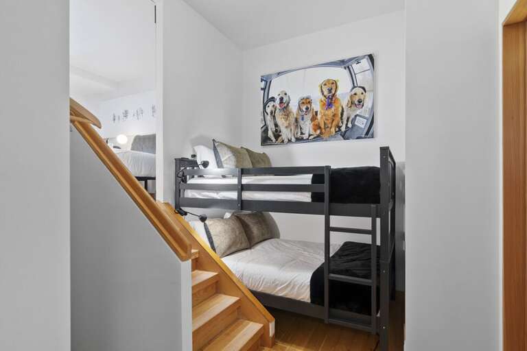 Guest Room Two features twin bunks with stairs leading to Guest Room Three.  These guest rooms share an ensuite bathroom.