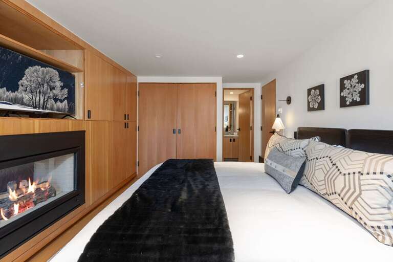 This guest room offers ample closet space as well as a gas fire to cozy up to as you get ready to sleep.