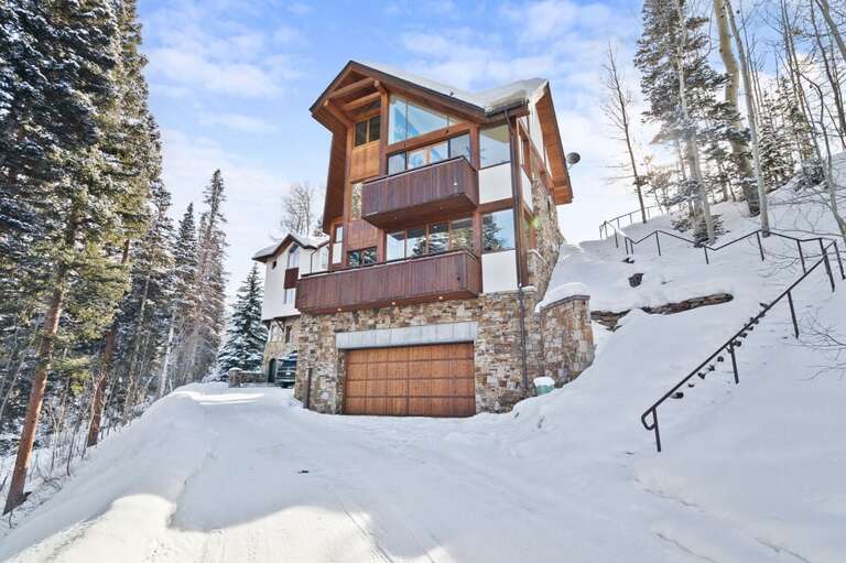 This house features a two car garage for parking as well as additional parking just a bit lower on the road.