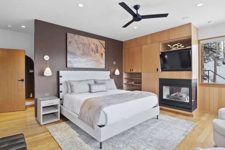 Primary bedroom complete with a cozy fireplace.