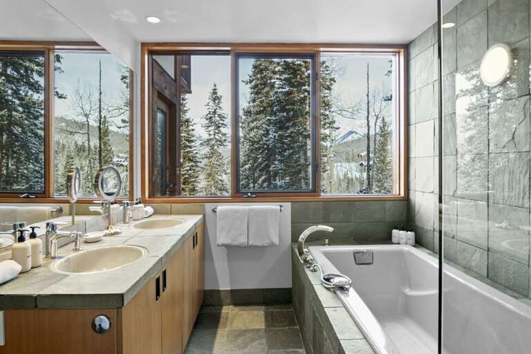 Primary en suite bathroom even has views! Along with a spacious tub and his and her sinks.