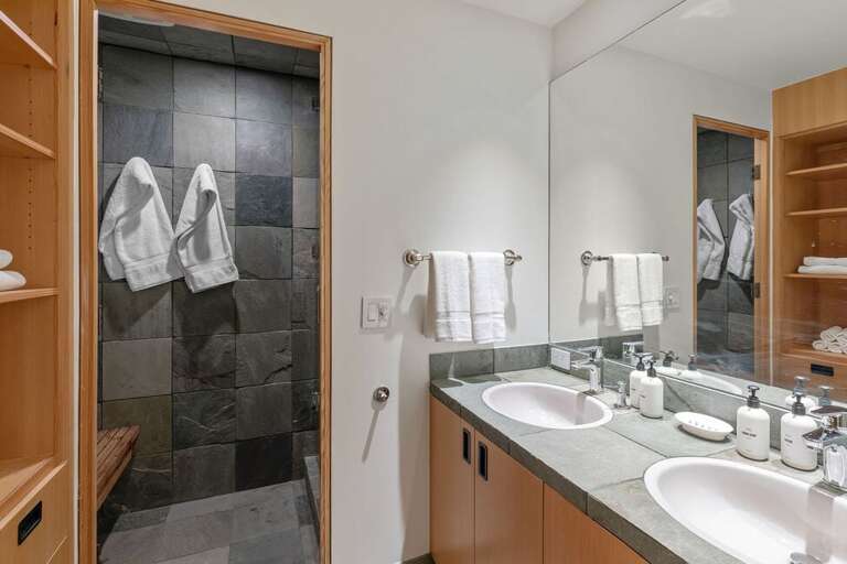 The shared Ensuite bathroom to Guest Room two and three feature a his and hers vanity as well as a step in shower.