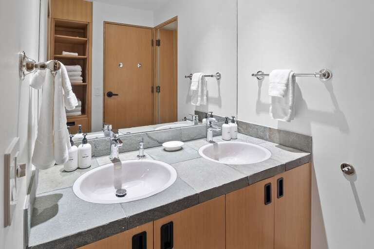 The shared Ensuite bathroom to Guest Room two and three feature a his and hers vanity as well as a step in shower.