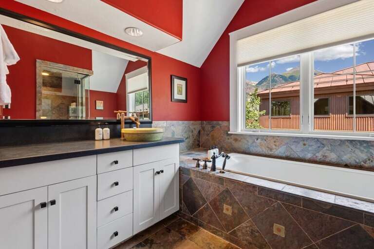 The ensuite bathroom with bathtub and walk in shower.
