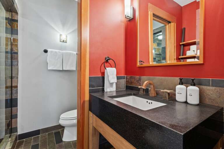 Full bathroom located next to the Guest Room features a step in shower and single sink vanity.